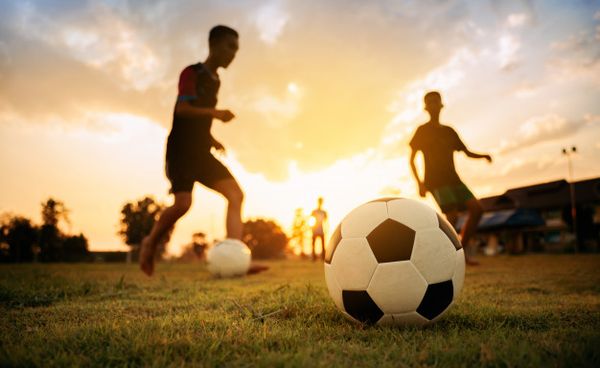 silhouete action sport outdoors group kids having fun playing soccer football 1